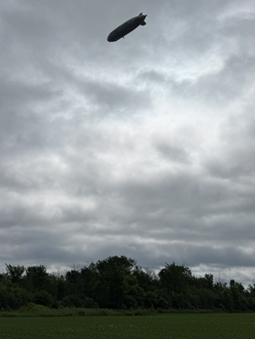 The Goodyear blimp flying over a field near Morrisburg
