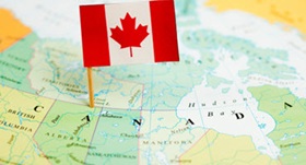Canadian flag over map of Canada
