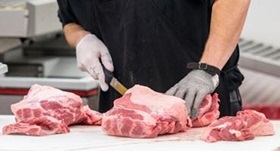 Man cutting pork